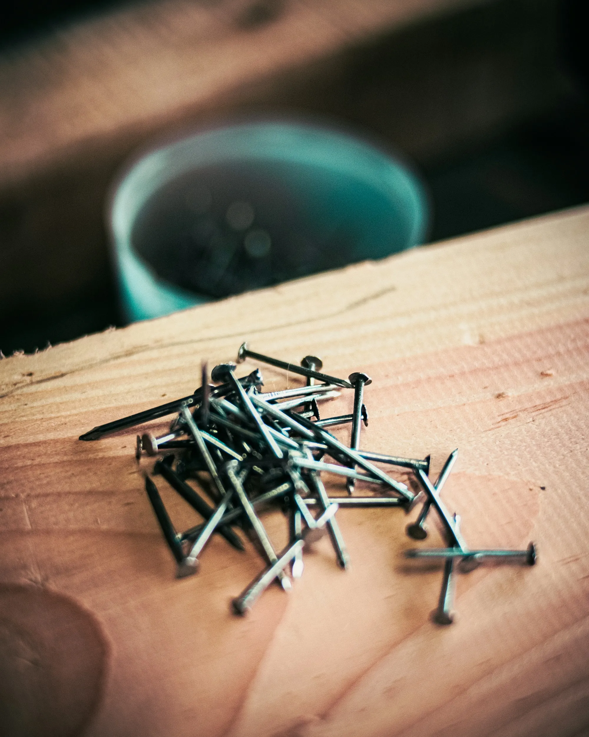Pile of nails on a wooden board